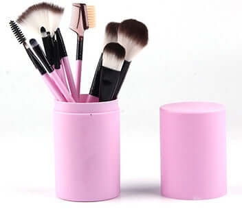 12-piece professional makeup brush set displayed in a pink barrel box, featuring various brush types for flawless application.