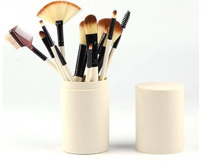12-piece professional makeup brush set in cream barrel box with various brushes for makeup application.