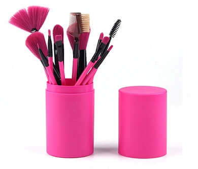 12-piece professional makeup brush set in a pink barrel box, featuring various brushes for flawless application.