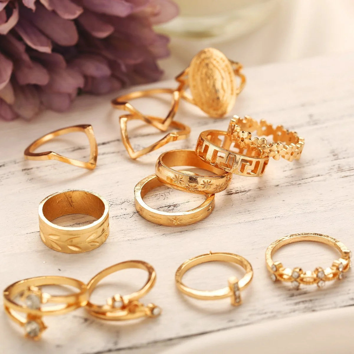 13-piece gold ring set featuring various styles and designs, perfect for stacking and fashion statements.