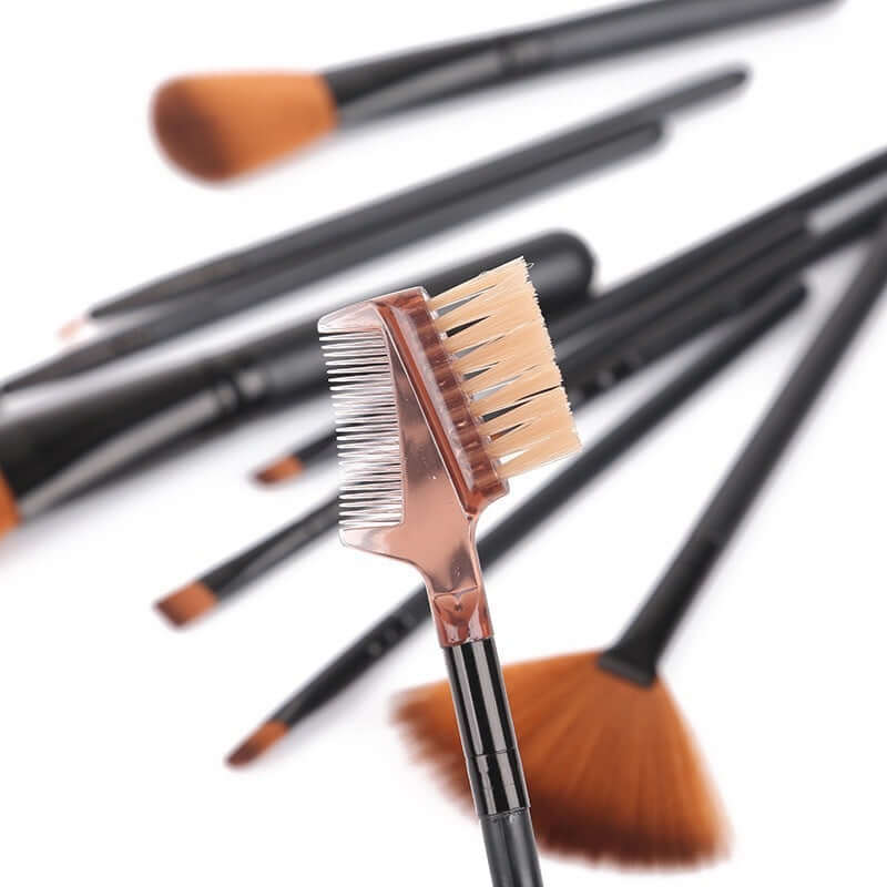 Close-up of a professional makeup brush set featuring eyebrow comb and various brush types for makeup application.