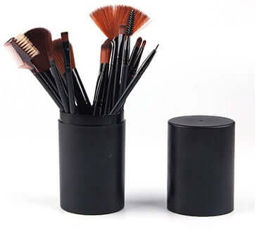 12-piece professional makeup brush set displayed in a sleek black barrel box, featuring various brush types for makeup application.