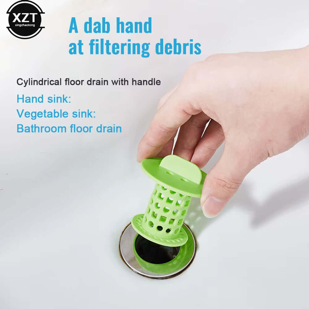 Hand holding a green cylindrical drain hair catcher in a sink, designed for filtering debris in bathrooms and kitchens.
